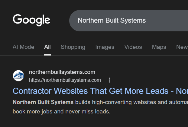 Circular stone fire pit surrounded by light-colored patio pavers with a coiled garden hose on the ground and a black metal fence with trees in the background.